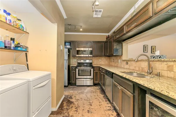 a kitchen with a sink stove and refrigerator