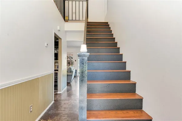 a view of entryway and hall with wooden floor