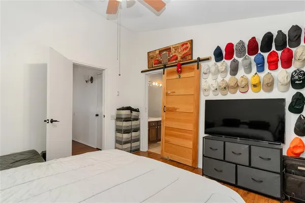 a bedroom with a bed and a television