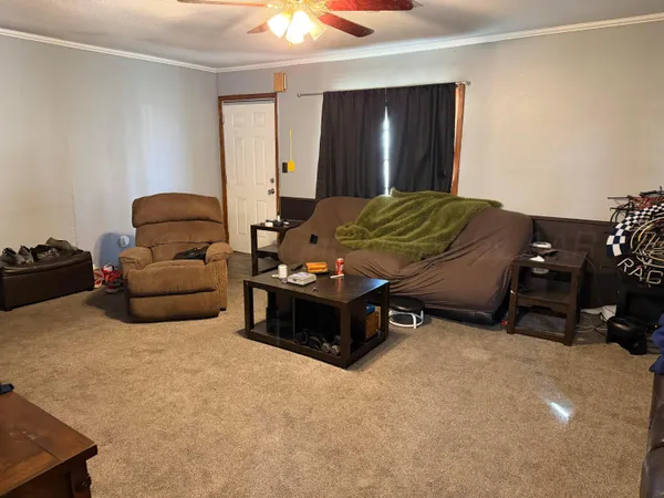 a living room with furniture and a lamp