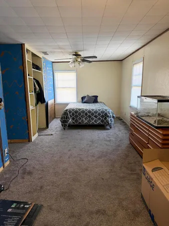 a bedroom with a bed and a window