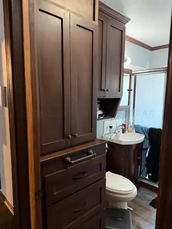 a bathroom with a sink a toilet and mirror