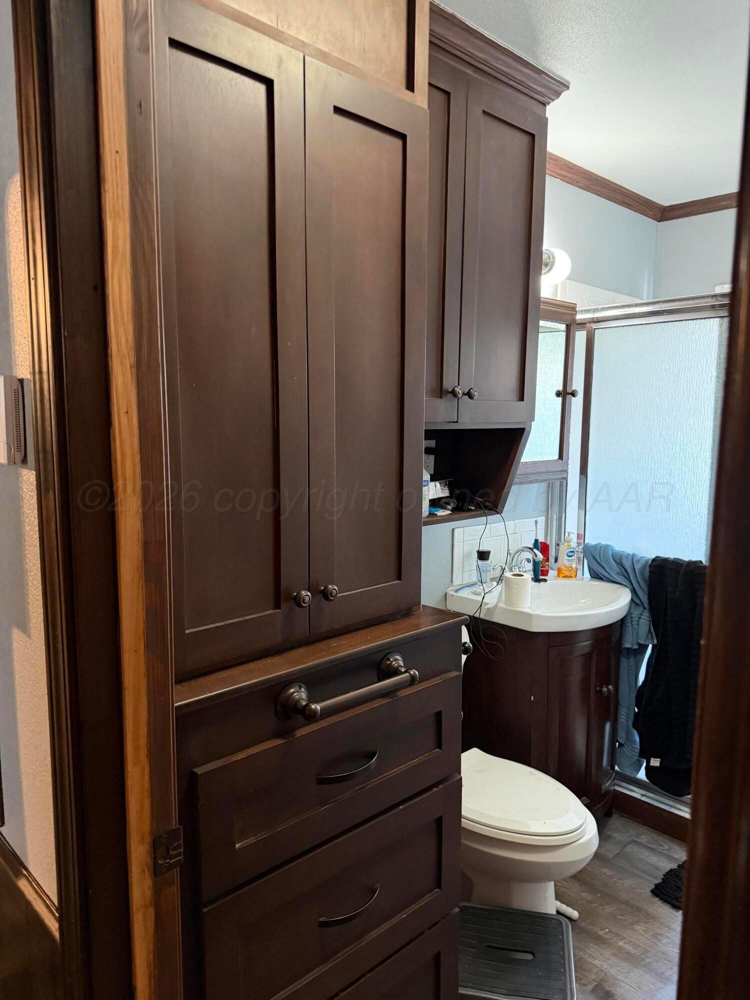 215 Hickory Street Borger, TX 79007 - Photo 5 of 18 a bathroom with a sink a toilet and mirror