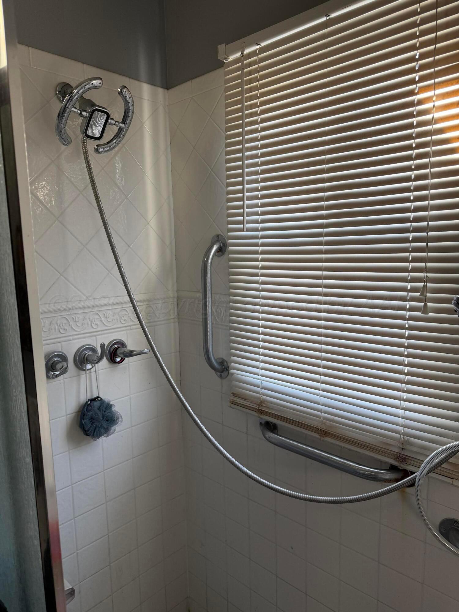 215 Hickory Street Borger, TX 79007 - Photo 6 of 18 a bathroom with a sink and a mirror