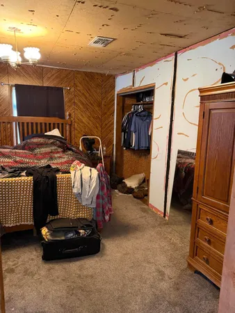 a bedroom with a bed and a tv