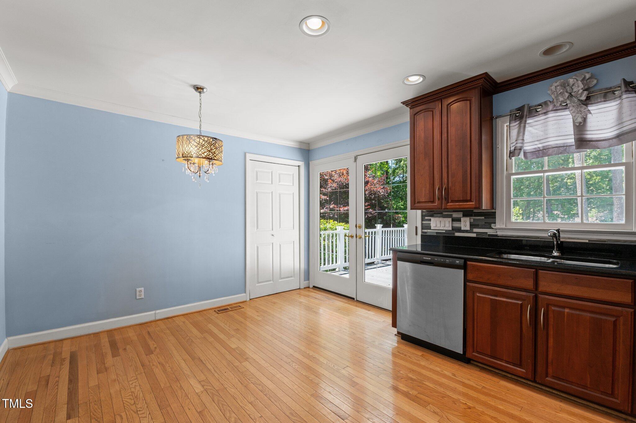 612 Harvest Lane Raleigh, NC 27606 - Photo 12 of 38 a view of a kitchen with a sink wooden cabinets and a window