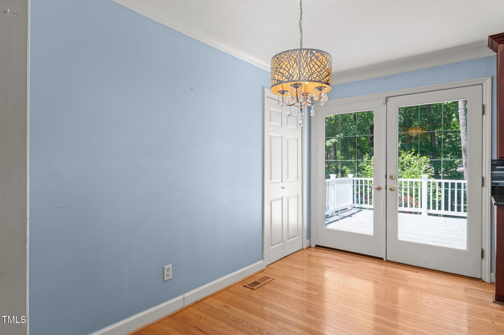 612 Harvest Lane Raleigh, NC 27606 - Photo 13 of 38 an empty room with wooden floor and windows