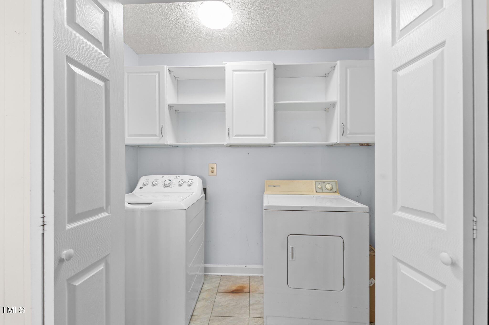 612 Harvest Lane Raleigh, NC 27606 - Photo 24 of 38 a view of storage and utility room with washer and dryer