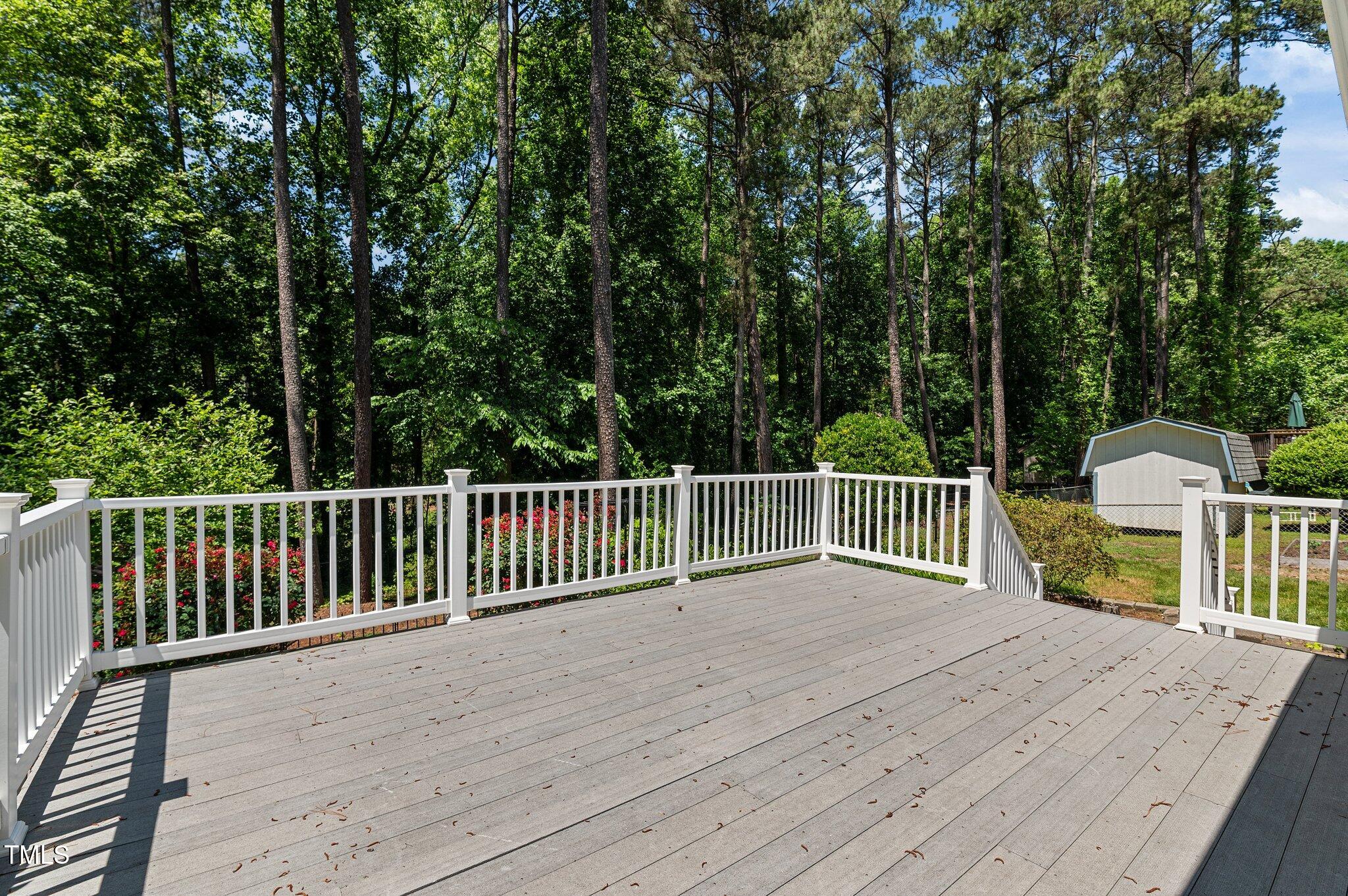 612 Harvest Lane Raleigh, NC 27606 - Photo 25 of 38 a view of a wooden deck and a backyard