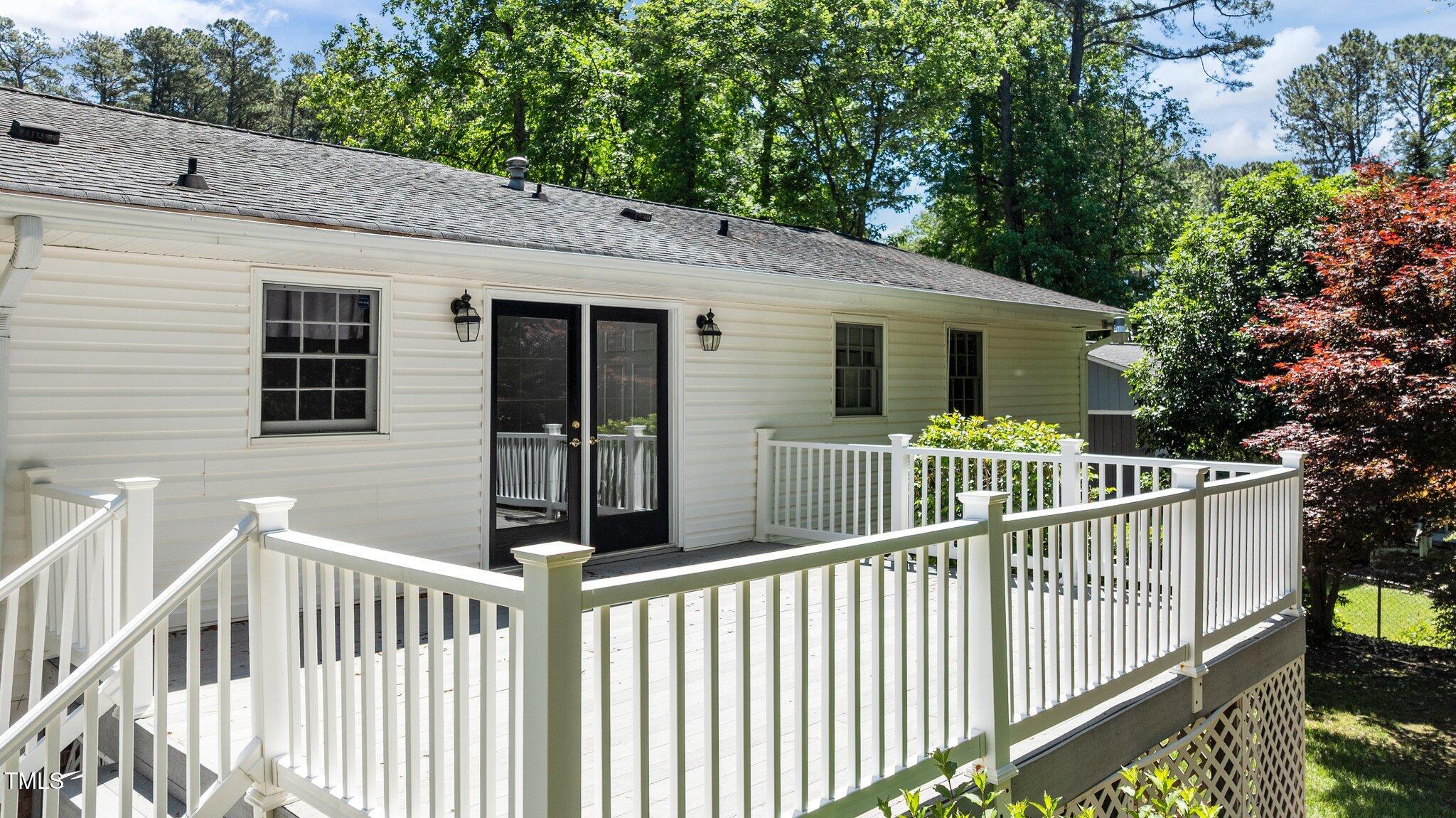 612 Harvest Lane Raleigh, NC 27606 - Photo 27 of 38 a view of a house with a wooden deck