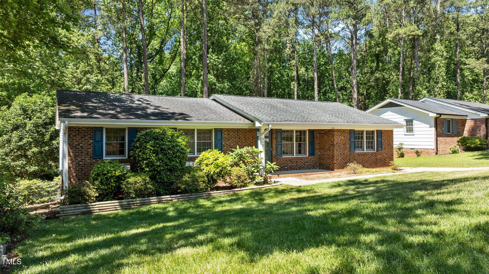 612 Harvest Lane Raleigh, NC 27606 - Photo 3 of 38 a front view of a house with a garden and porch