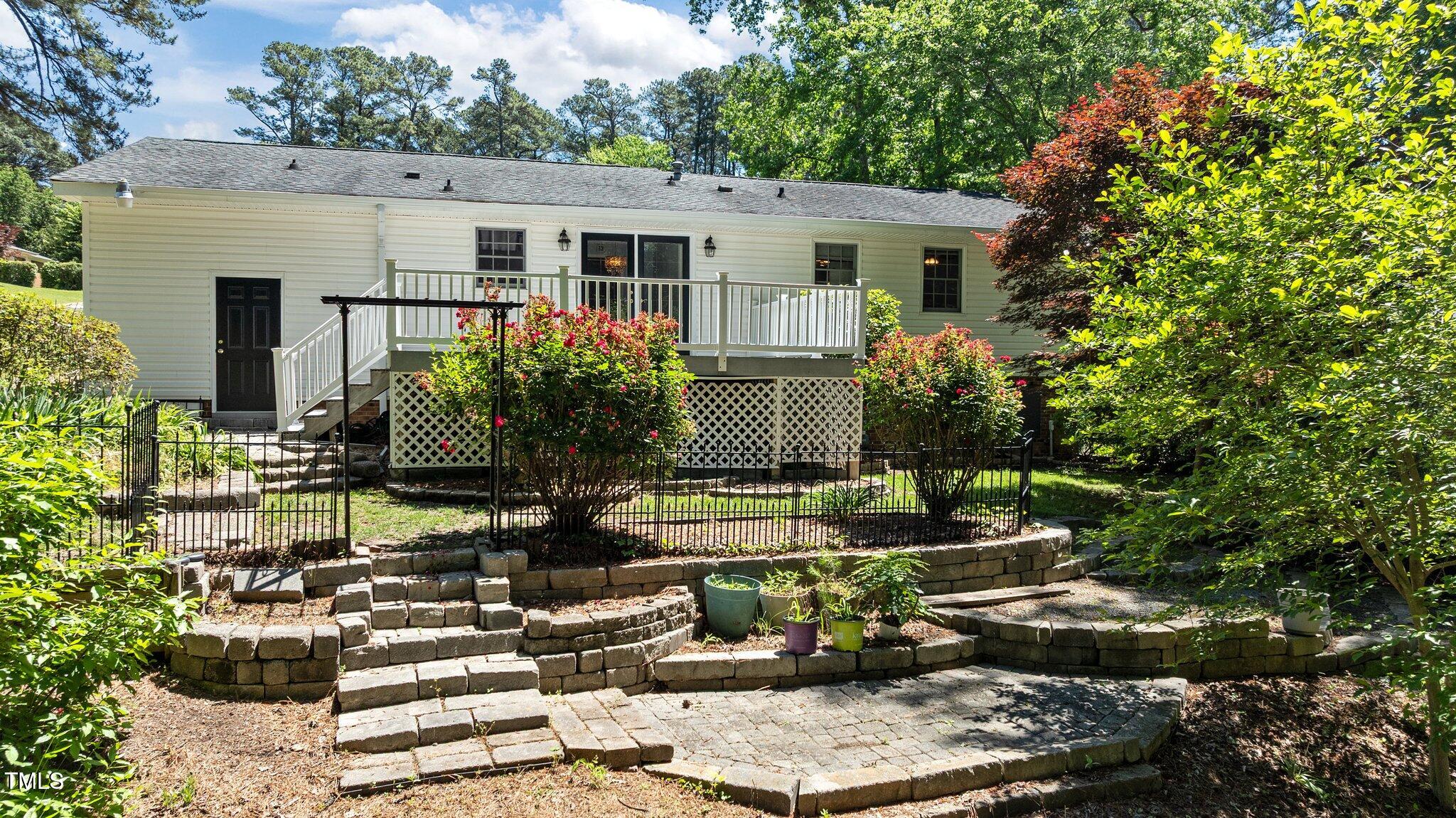 612 Harvest Lane Raleigh, NC 27606 - Photo 31 of 38 a front view of house with yard seating and green space