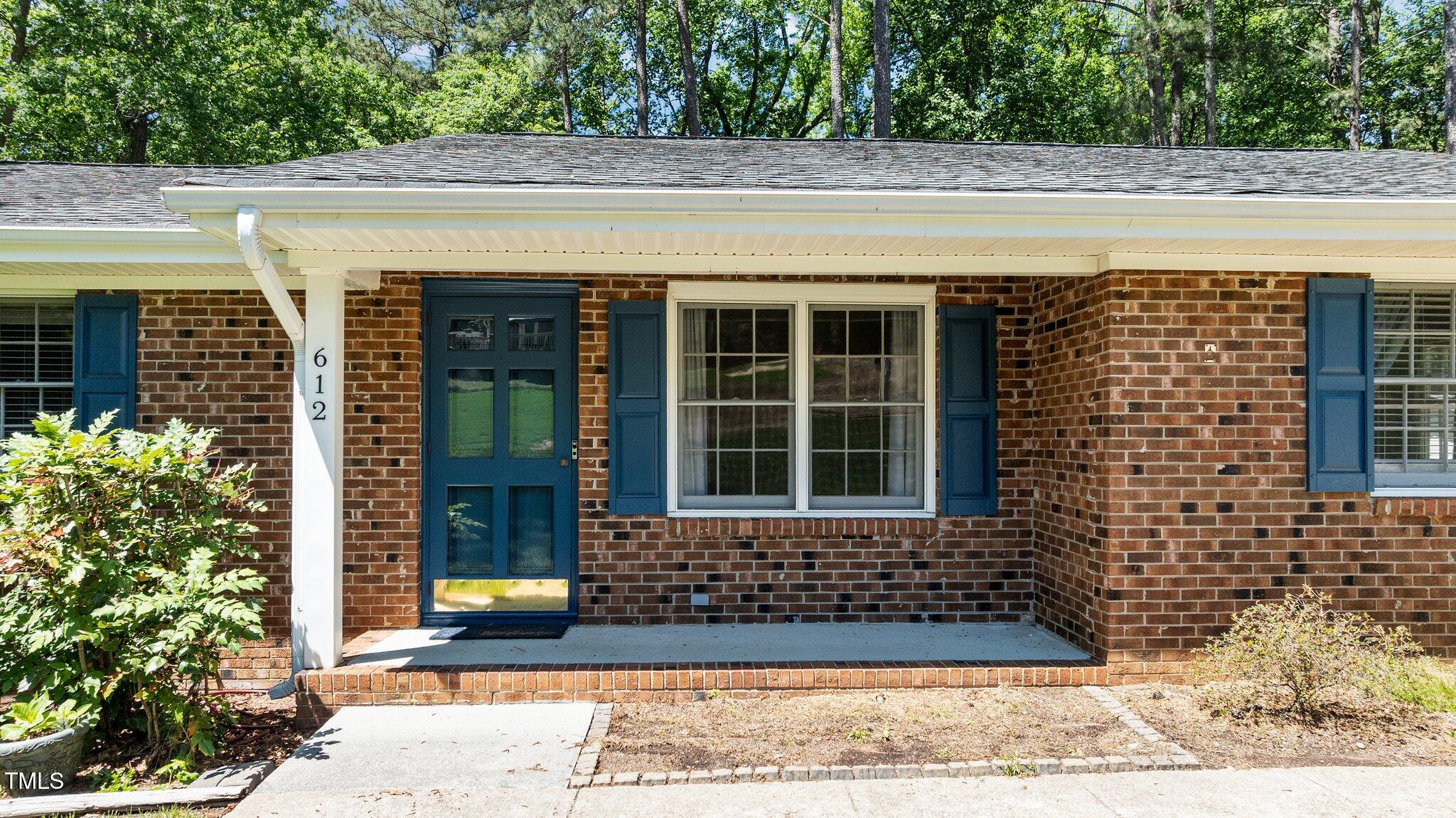 612 Harvest Lane Raleigh, NC 27606 - Photo 4 of 38 a view of a brick house with a outdoor space