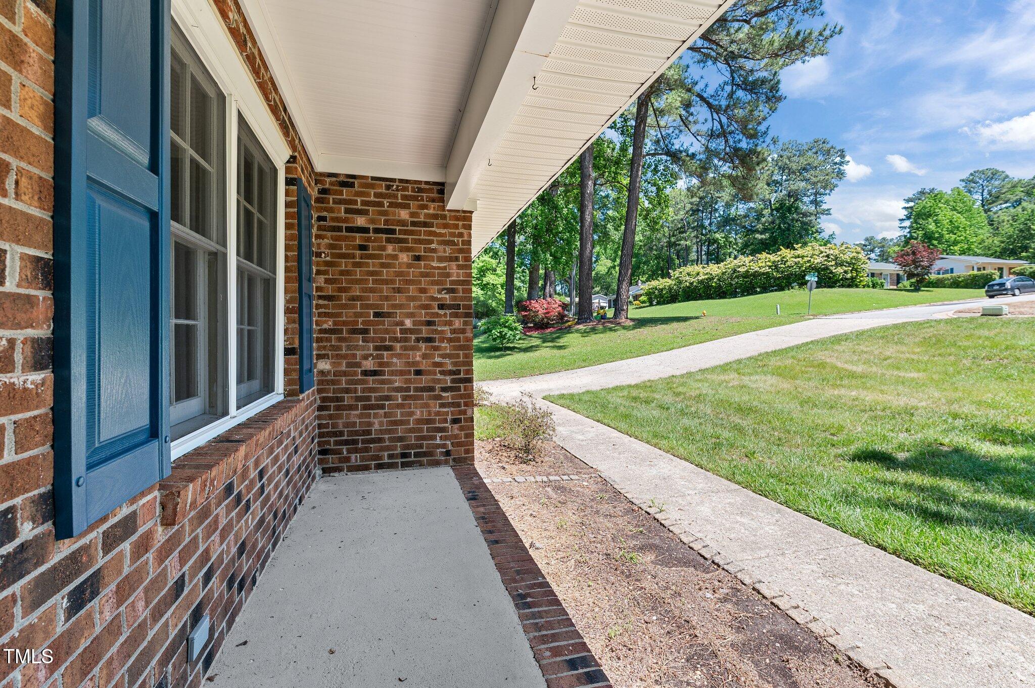 612 Harvest Lane Raleigh, NC 27606 - Photo 5 of 38 a view of a pathway of a building with a yard