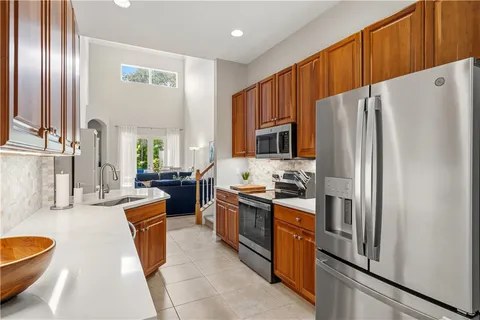 a kitchen with stainless steel appliances granite countertop a refrigerator stove and sink