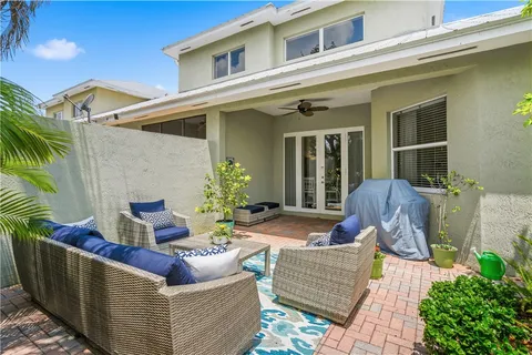 a view of a house with couches and a potted plant