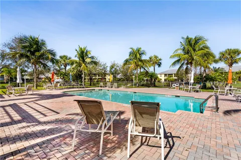 a view of a swimming pool and lounge chair