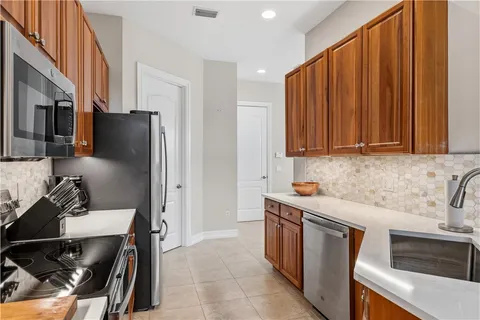 a kitchen with stainless steel appliances a stove a sink and a refrigerator