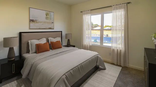 a bedroom with a bed and painting on the wall