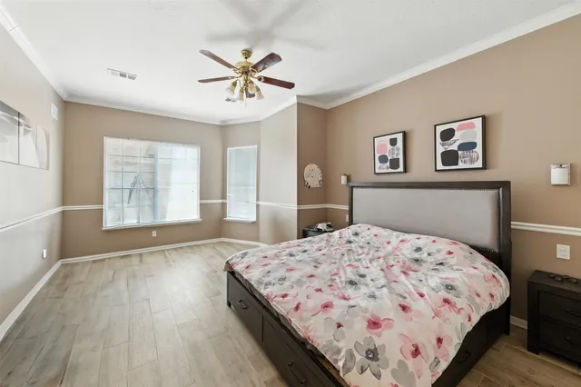 a bedroom with a large bed and a chandelier