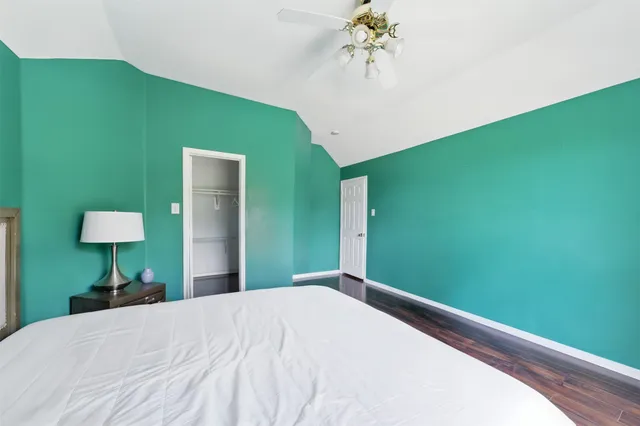 a bedroom with a bed and a potted plant
