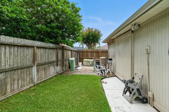 a view of a backyard with a patio and a garden