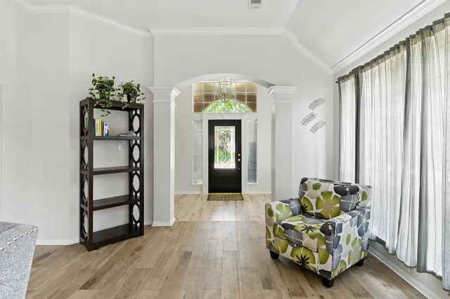 a hallway with furniture and a potted plant