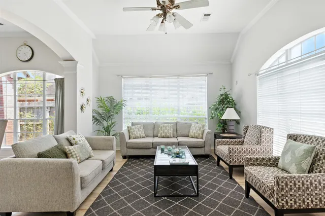 a living room with furniture and a large window