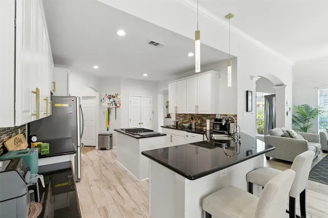 a kitchen with counter space appliances and a dining table