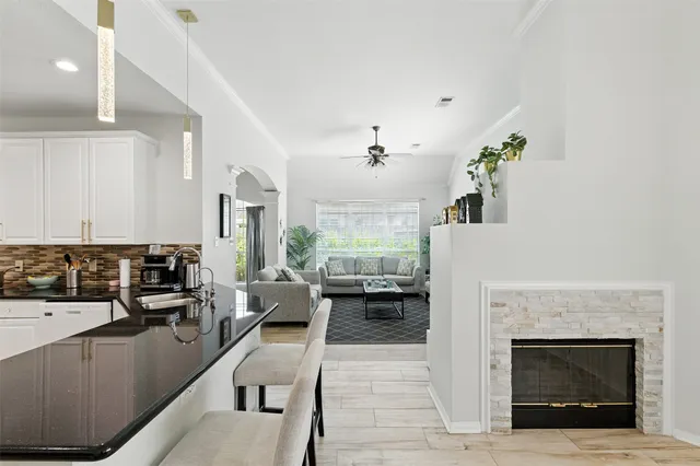 a living room with furniture and a fireplace