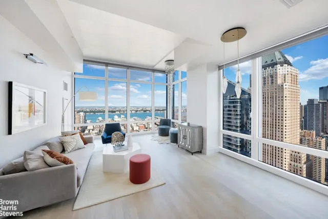 a living room with furniture and large windows