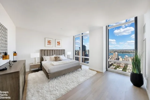 a bedroom with a large bed and a large window