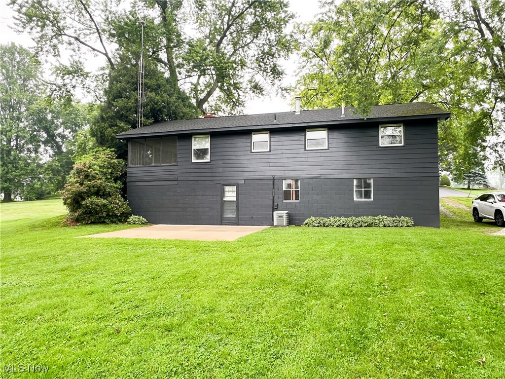 232 Hoffman Road Loudonville, OH 44842 - Photo 24 of 28 Rear view of house with a patio and a lawn