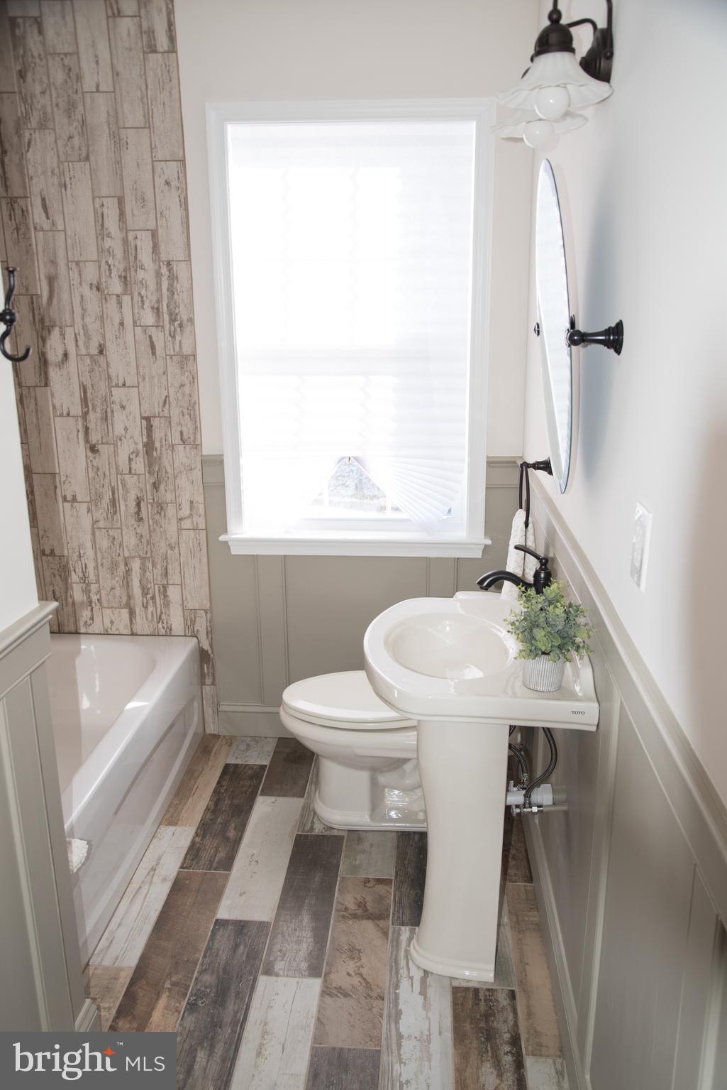 4130 Fairfax Road Baltimore, MD 21216 - Photo 13 of 30 a bath room with a toilet and a bath tub