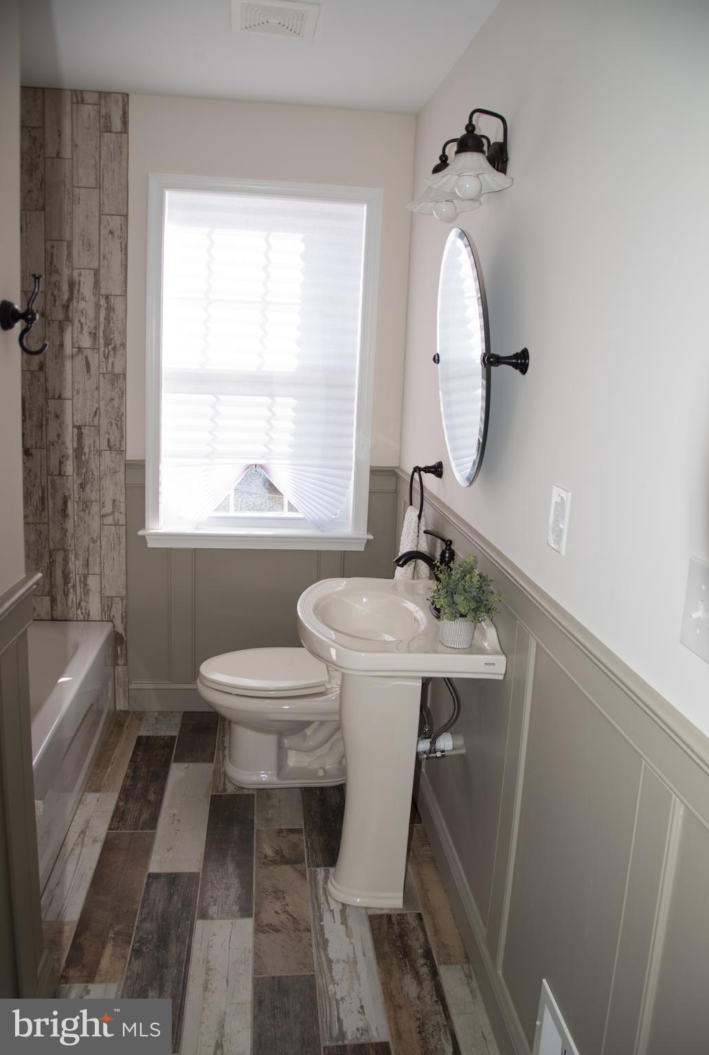 4130 Fairfax Road Baltimore, MD 21216 - Photo 16 of 30 a bathroom with a sink a toilet and a tub