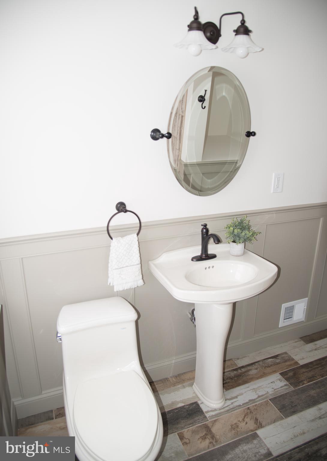 4130 Fairfax Road Baltimore, MD 21216 - Photo 21 of 30 a bathroom with a toilet sink and mirror