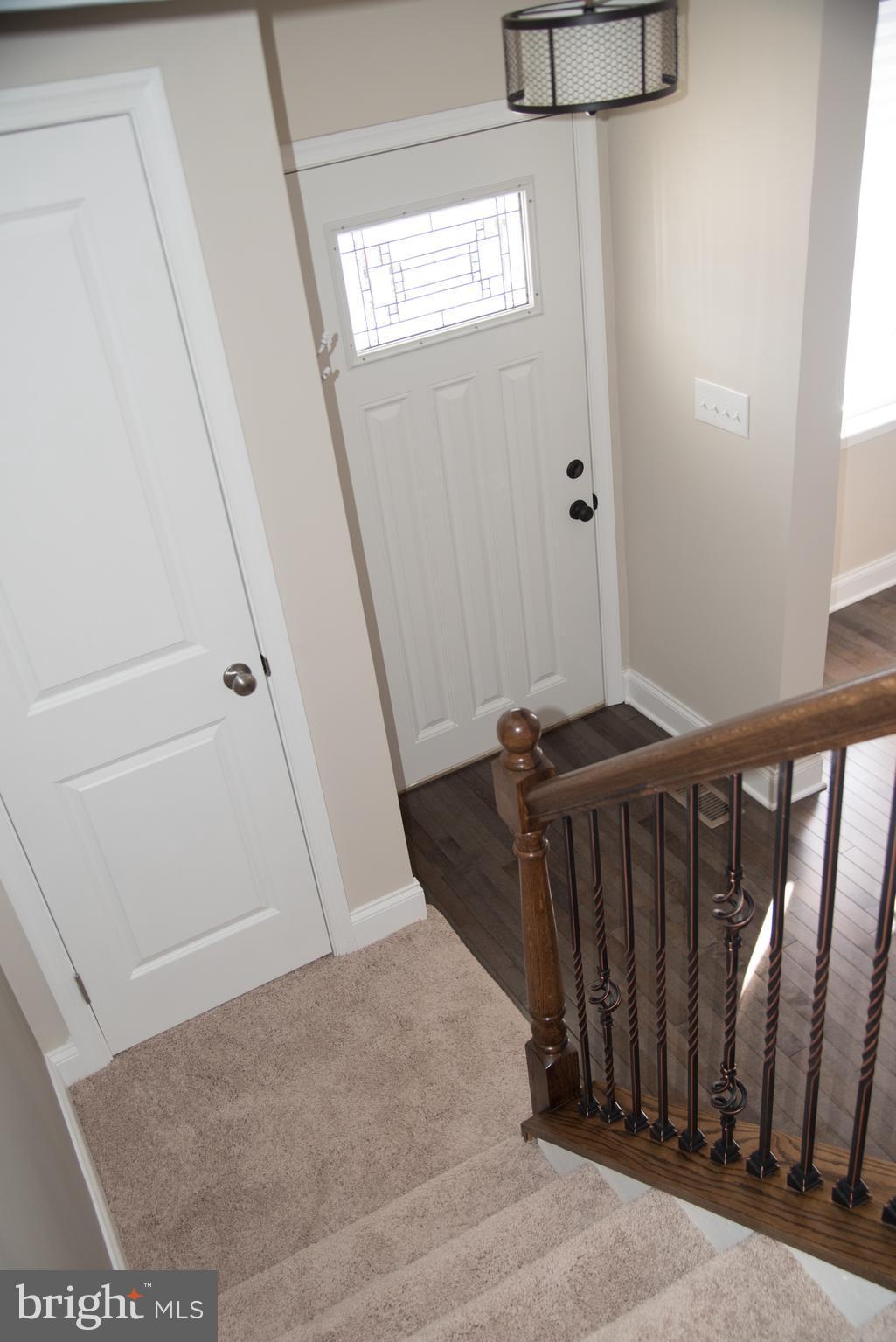 4130 Fairfax Road Baltimore, MD 21216 - Photo 22 of 30 a view of a hallway with wooden floor and stairs