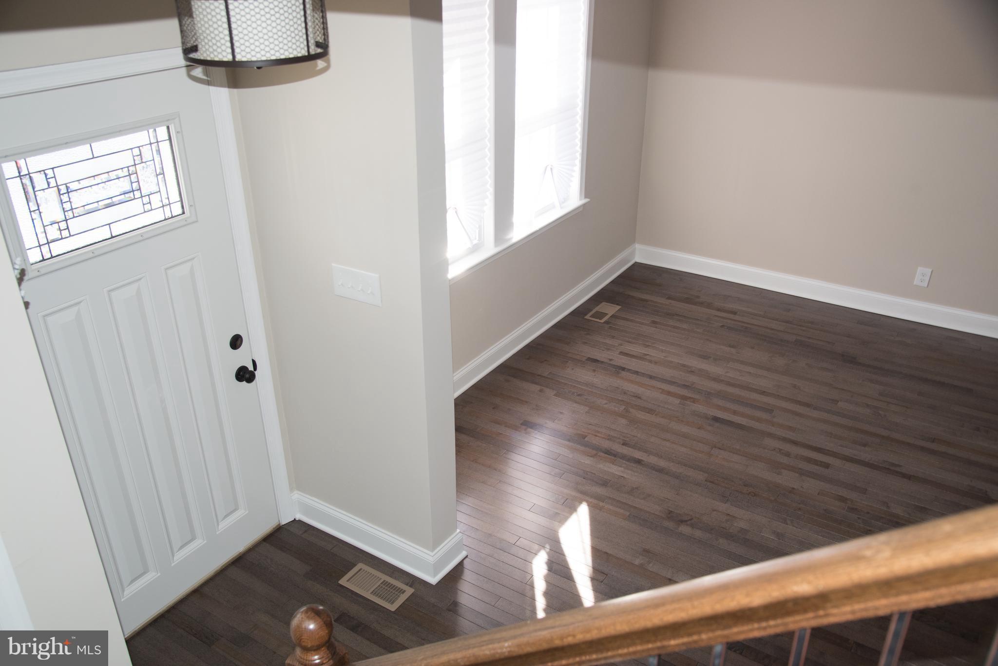 4130 Fairfax Road Baltimore, MD 21216 - Photo 23 of 30 a view of an empty room with wooden floor and a window