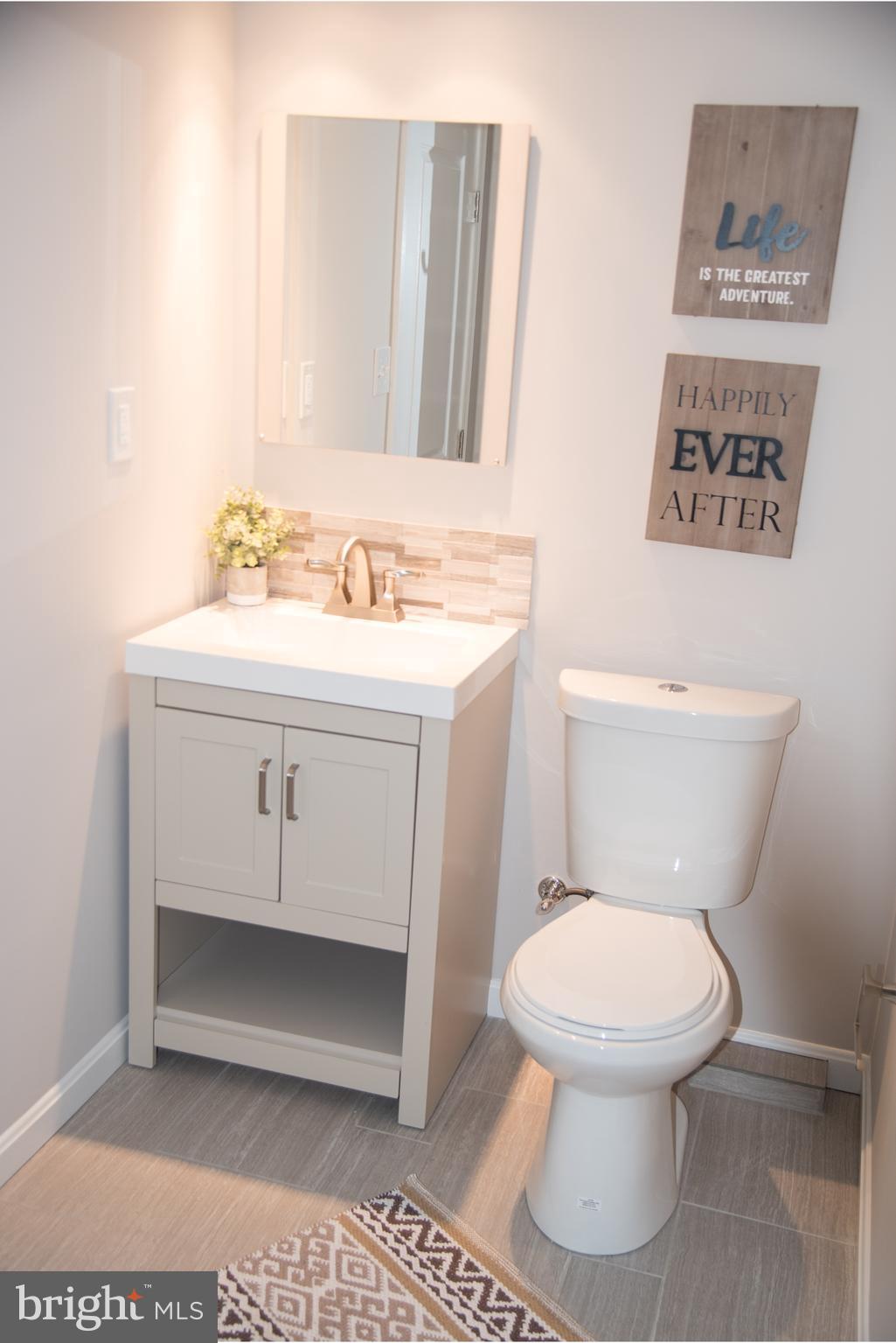 4130 Fairfax Road Baltimore, MD 21216 - Photo 25 of 30 a bathroom with a toilet a sink and mirror