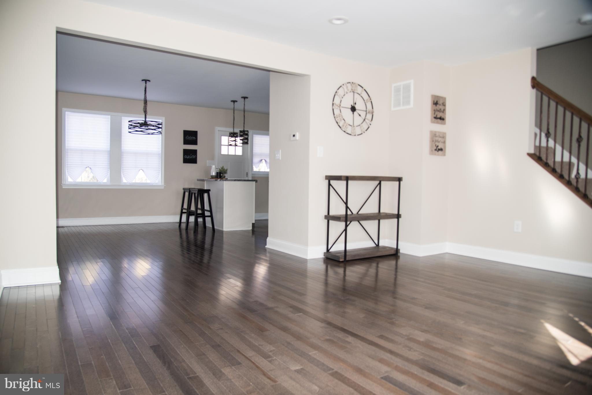 4130 Fairfax Road Baltimore, MD 21216 - Photo 4 of 30 a view of a hallway with wooden floor and a large window