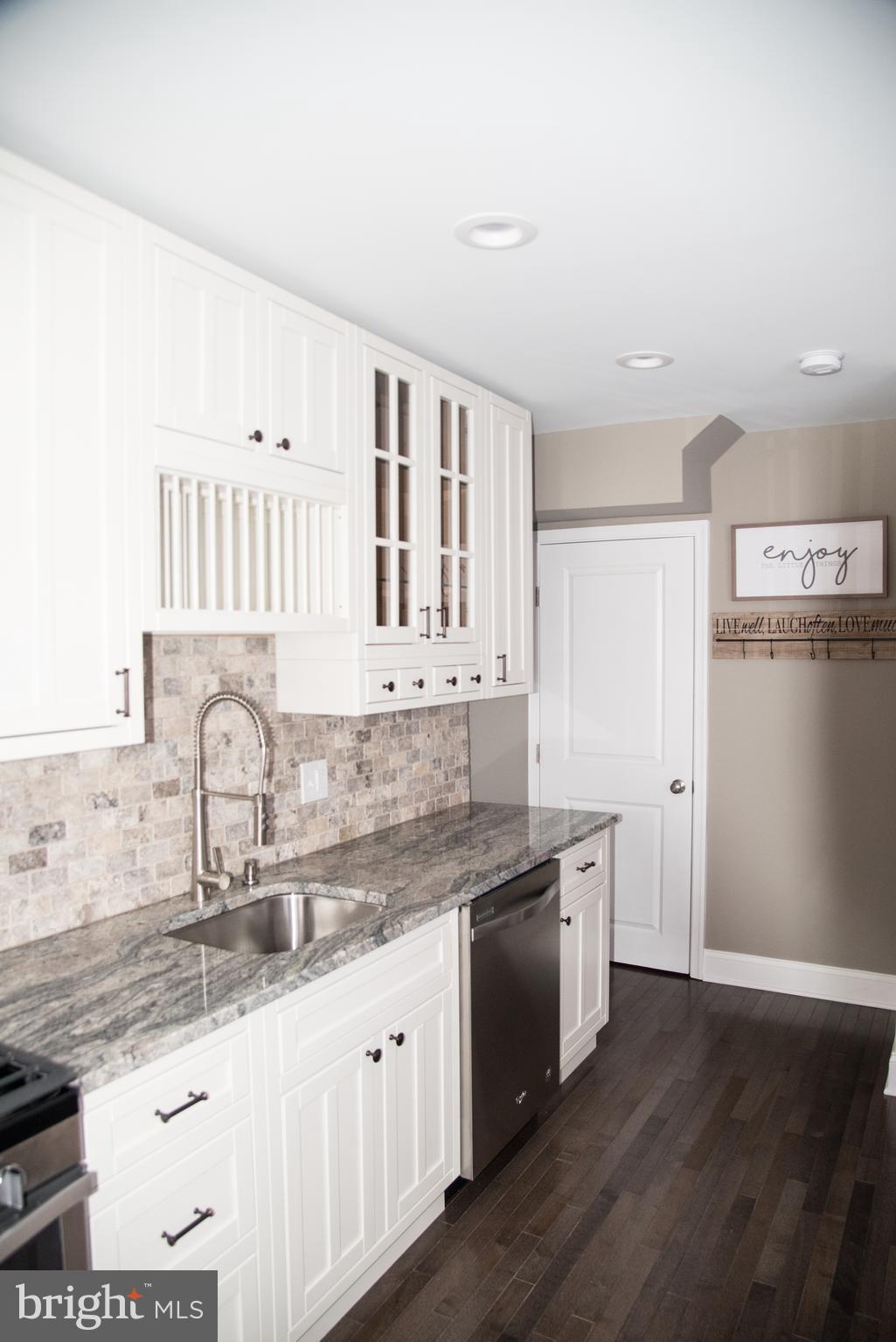 4130 Fairfax Road Baltimore, MD 21216 - Photo 10 of 30 a kitchen with granite countertop a sink and cabinets