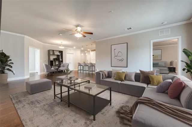a living room with furniture kitchen view and a table