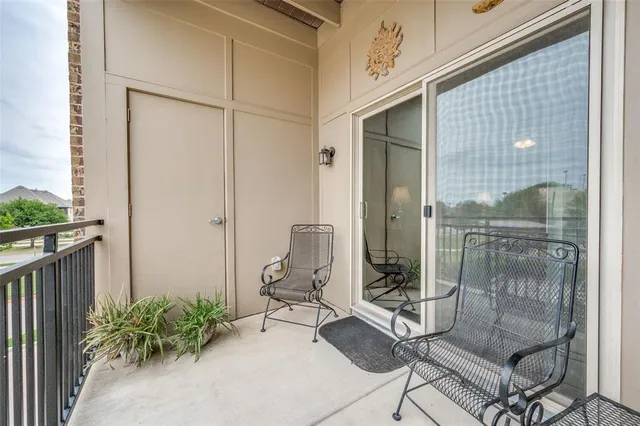 a view of a hallway with wooden floor and a kitchen