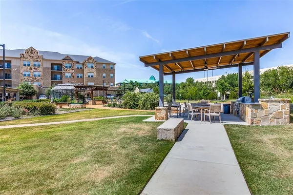 an aerial view of residential houses with outdoor space and parking