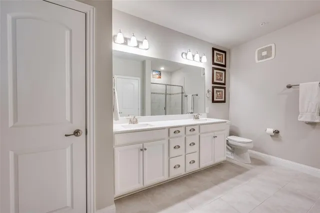 a bathroom with a bathtub shower sink mirror vanity and toilet