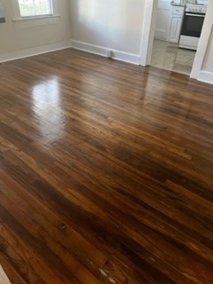 1360 Rhodes Street, Unit C Columbus, GA 31901 - Photo 6 of 12 an empty room with wooden floor and windows