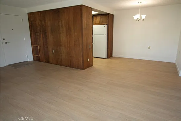 a view of an empty room with closet area