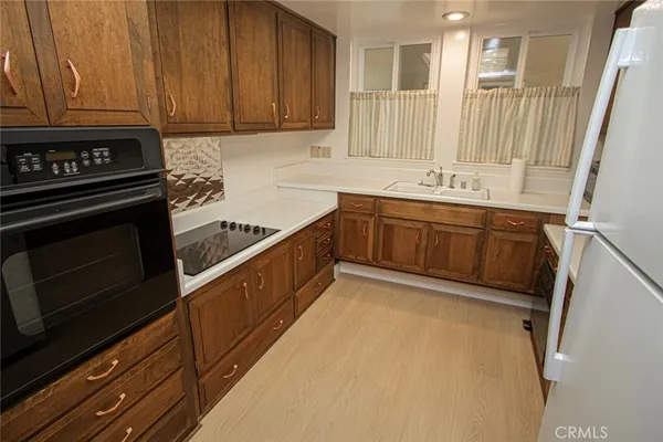 a kitchen with granite countertop cabinets stainless steel appliances and a counter space