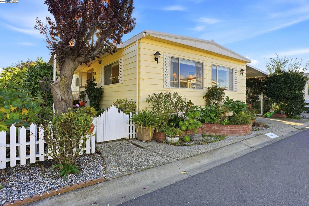 4141 Deep Creek Road Fremont, CA 94555 - Photo 3 of 54 a front view of a house with a yard and potted plants