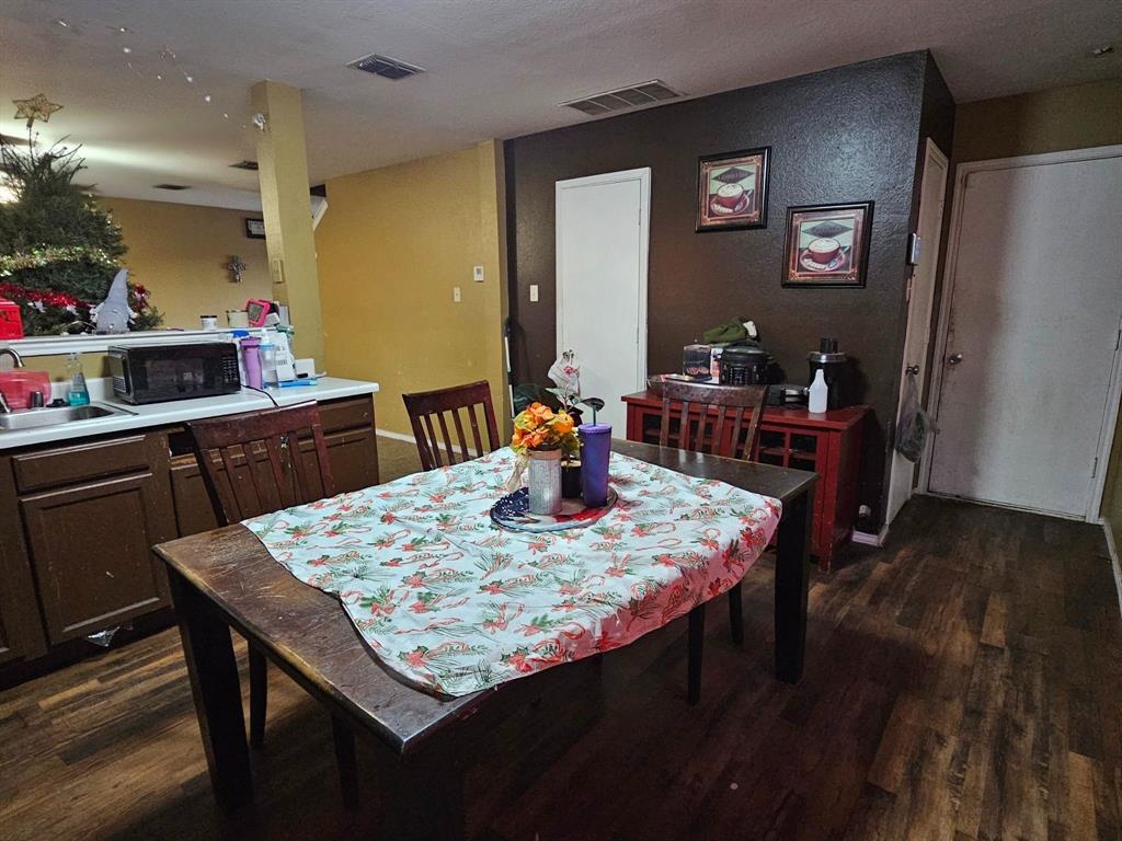 237 Cres Ridge Drive Fort Worth, TX 76140 - Photo 7 of 11 a dining table with chairs and wooden floor